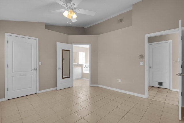 unfurnished room featuring visible vents, baseboards, light tile patterned flooring, vaulted ceiling, and a ceiling fan