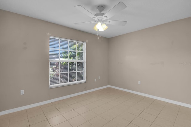 spare room featuring baseboards and a ceiling fan