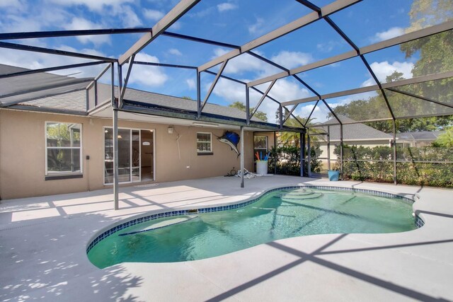 outdoor pool featuring a lanai and a patio area