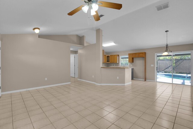 unfurnished living room with visible vents, a ceiling fan, vaulted ceiling, and baseboards