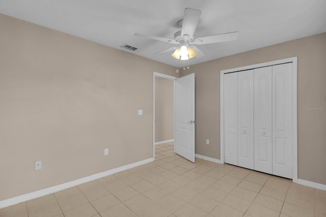 unfurnished bedroom with a closet, visible vents, ceiling fan, and baseboards