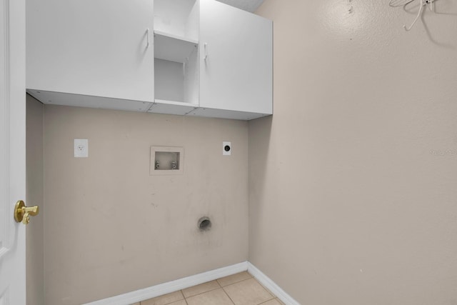 clothes washing area featuring hookup for an electric dryer, cabinet space, light tile patterned flooring, hookup for a washing machine, and baseboards