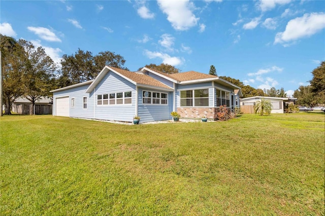 exterior space with a garage and a lawn