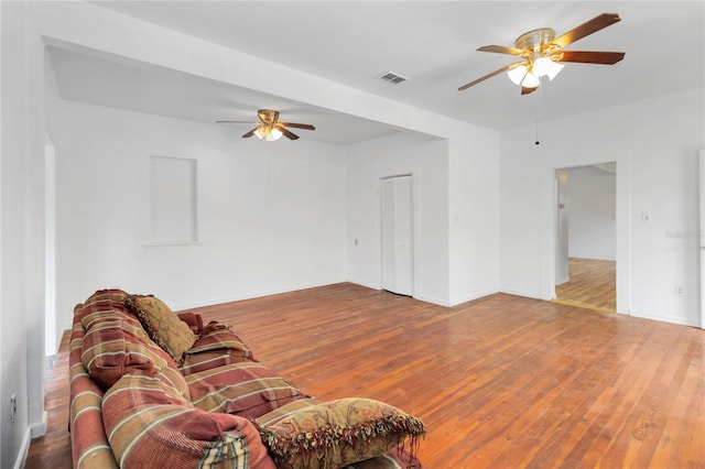 living room with hardwood / wood-style flooring and ceiling fan