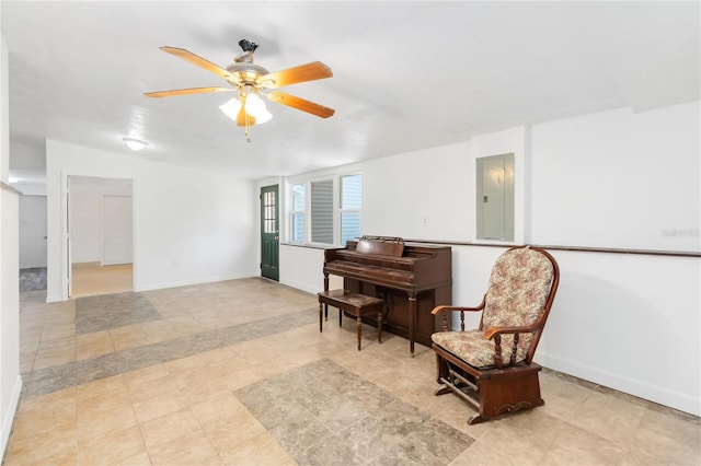 living area featuring electric panel and ceiling fan