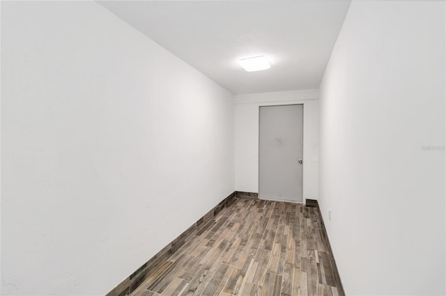 unfurnished room with wood-type flooring