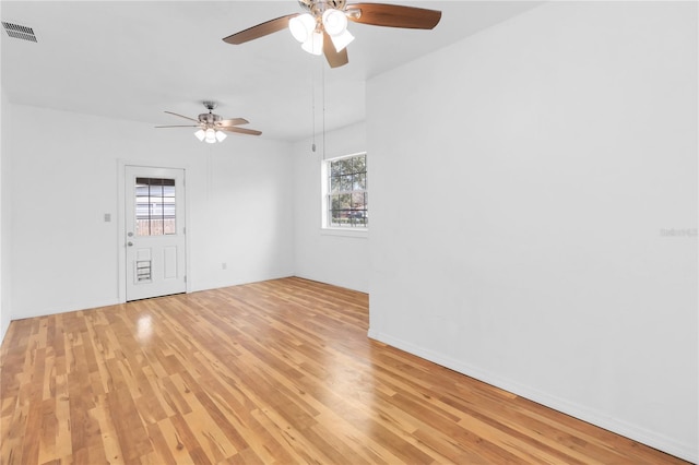 spare room featuring ceiling fan and light hardwood / wood-style flooring