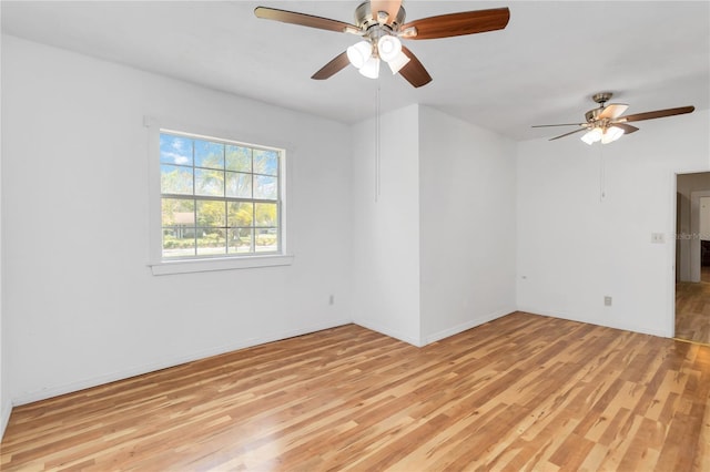 empty room with ceiling fan and light hardwood / wood-style floors