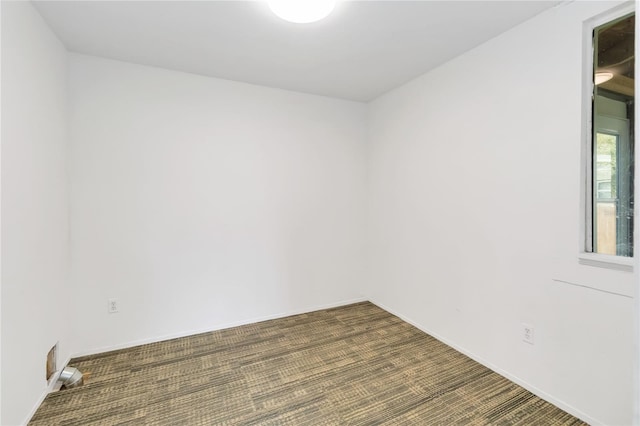 empty room featuring dark carpet