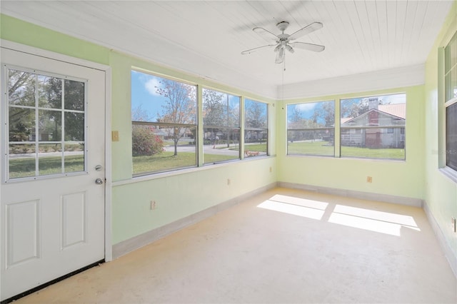 unfurnished sunroom with ceiling fan