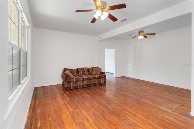 living area with ceiling fan and dark hardwood / wood-style floors