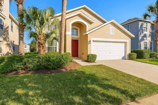 8595 Sunrise Key Dr, Kissimmee, FL 34747 - view of front of home featuring concrete driveway, stucco siding, a front lawn, and a garage