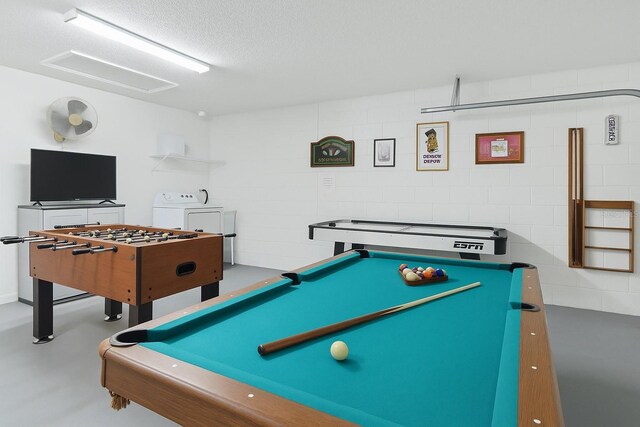8595 Sunrise Key Dr, Kissimmee, FL 34747 - playroom with independent washer and dryer, billiards, finished concrete flooring, and a textured ceiling