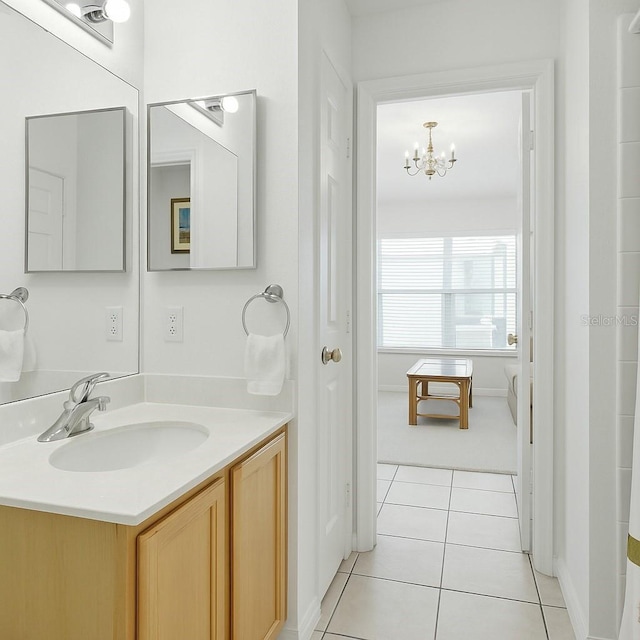 8595 Sunrise Key Dr, Kissimmee, FL 34747 - bathroom featuring vanity, tile patterned flooring, and a chandelier