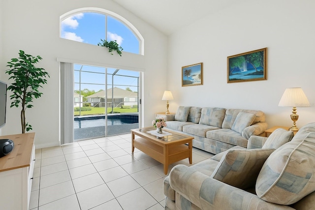 8595 Sunrise Key Dr, Kissimmee, FL 34747 - living room featuring light tile patterned flooring and high vaulted ceiling