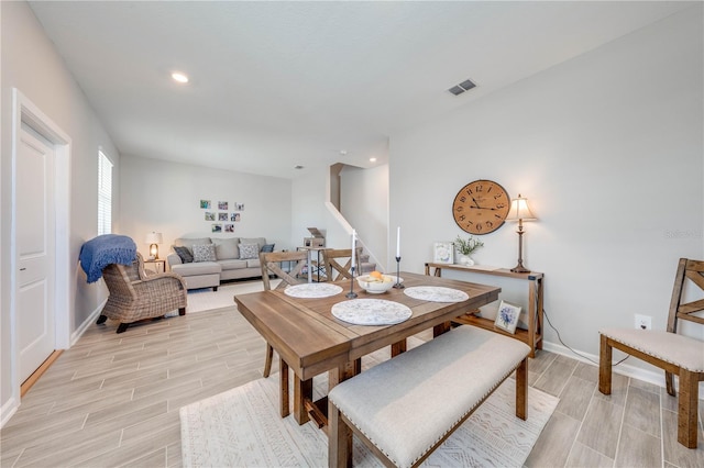 dining area featuring recessed lighting, visible vents, stairway, wood tiled floor, and baseboards