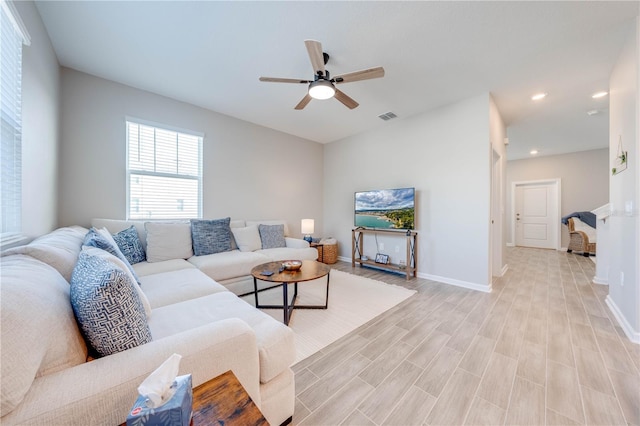 living area with visible vents, baseboards, light wood-style flooring, ceiling fan, and recessed lighting