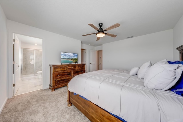 bedroom with ceiling fan, connected bathroom, light colored carpet, visible vents, and baseboards