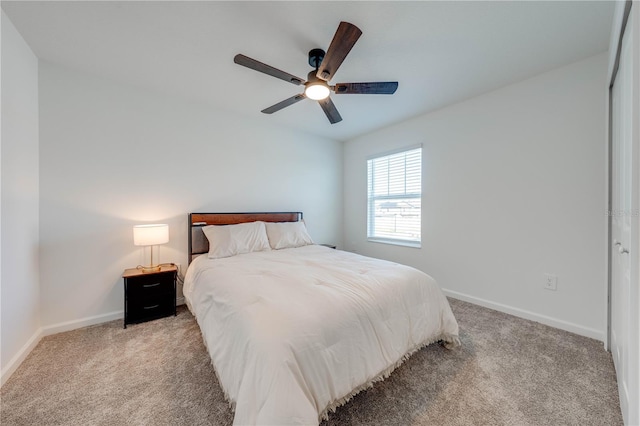 bedroom featuring light carpet, baseboards, and a ceiling fan