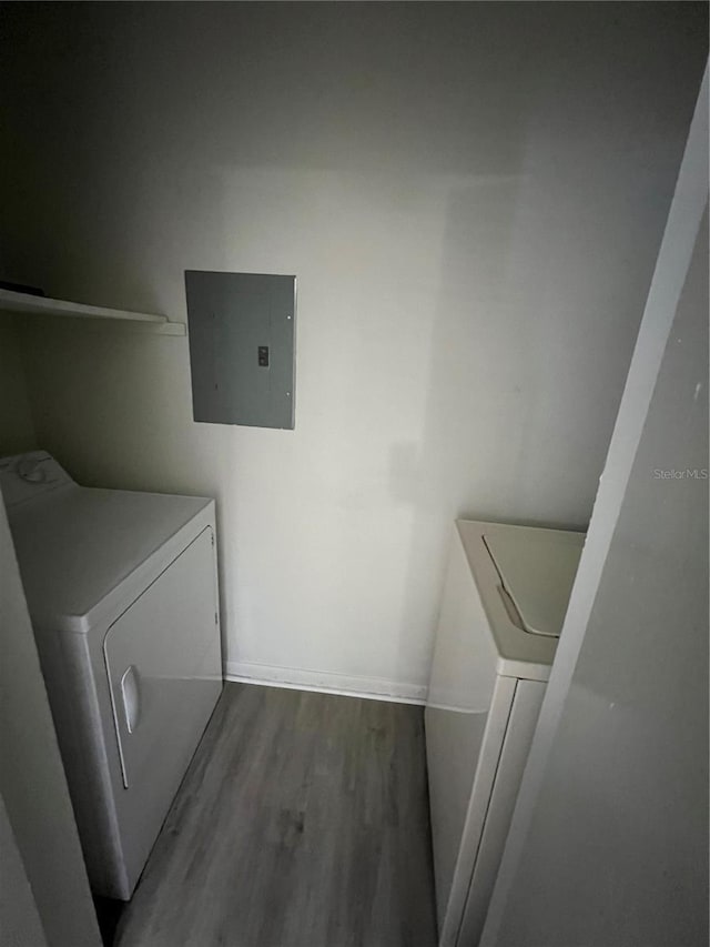 laundry area featuring hardwood / wood-style flooring, washer / dryer, and electric panel