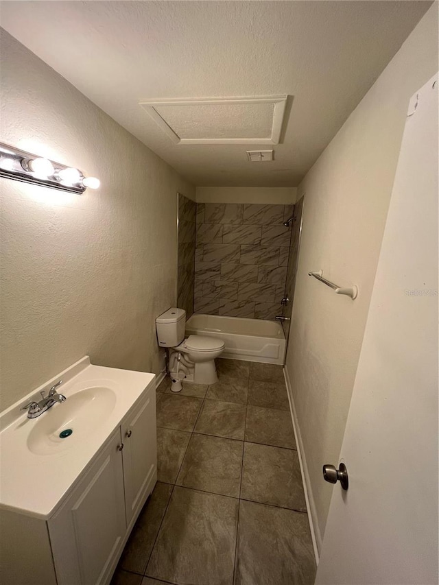 full bathroom with tiled shower / bath, tile patterned flooring, vanity, toilet, and a textured ceiling