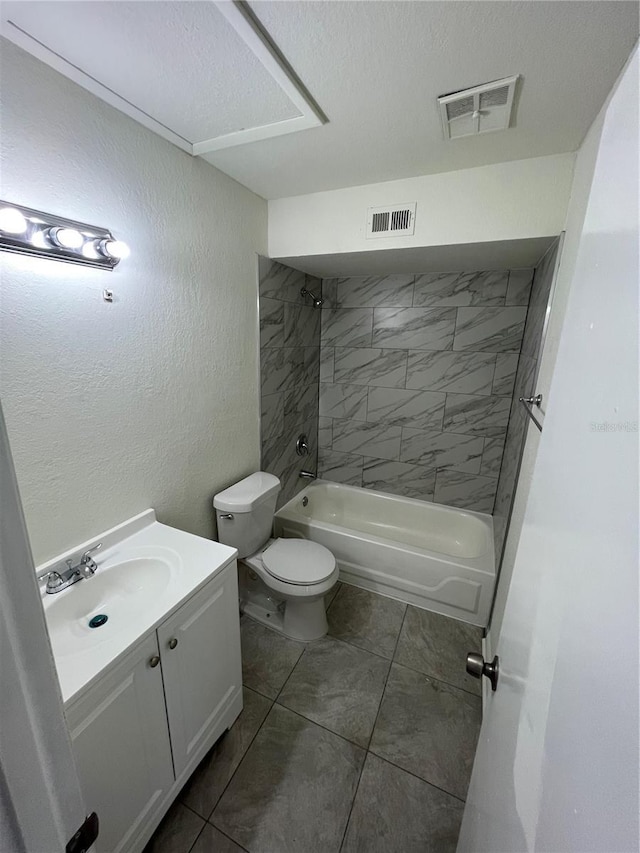 full bathroom with vanity, toilet, tiled shower / bath combo, and a textured ceiling