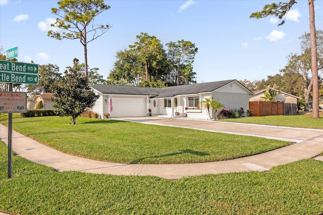 single story home with a garage and a front lawn