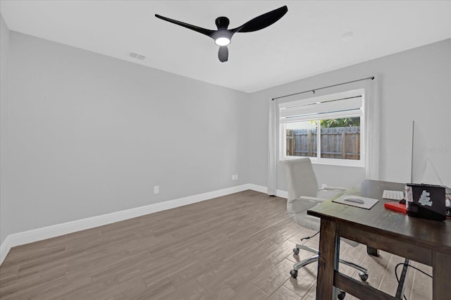 unfurnished office featuring wood-type flooring and ceiling fan