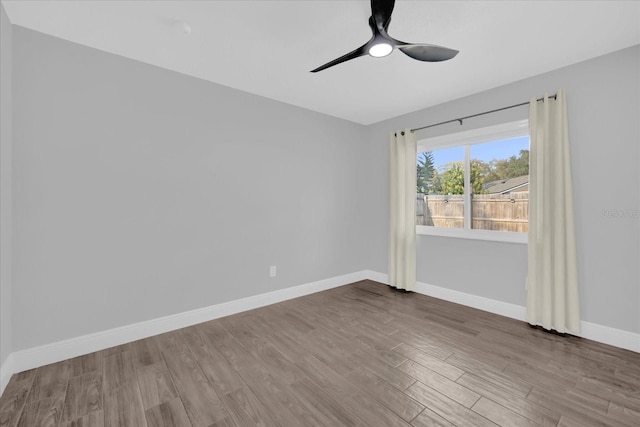 spare room with hardwood / wood-style flooring and ceiling fan