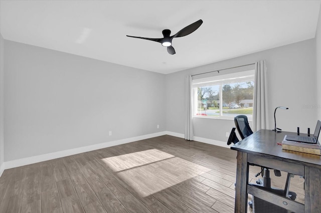 unfurnished office featuring ceiling fan and wood-type flooring