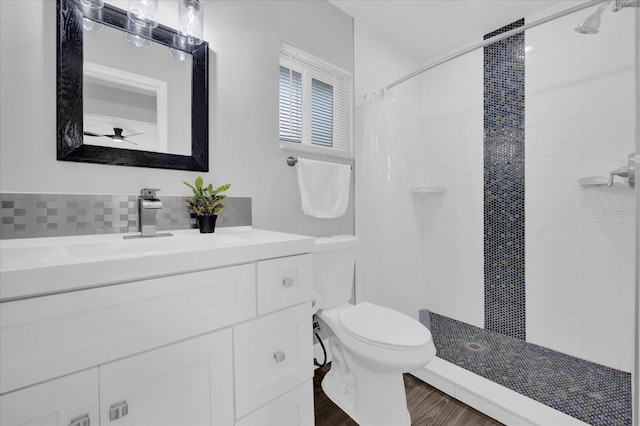 bathroom with walk in shower, hardwood / wood-style floors, vanity, and toilet