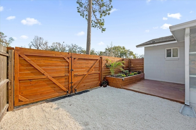 view of gate featuring a patio area