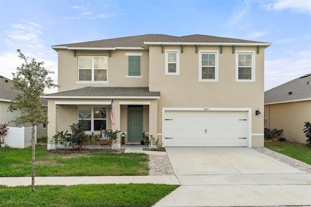 view of front of home featuring a garage and a front yard