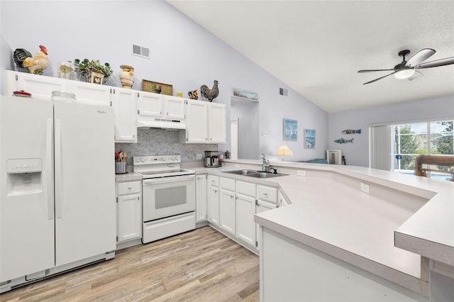 kitchen featuring lofted ceiling, sink, white cabinetry, white appliances, and light hardwood / wood-style floors