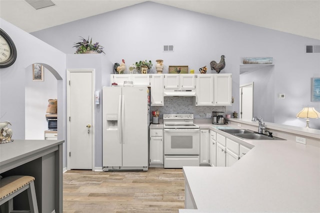 kitchen with lofted ceiling, sink, white cabinetry, light hardwood / wood-style flooring, and white appliances