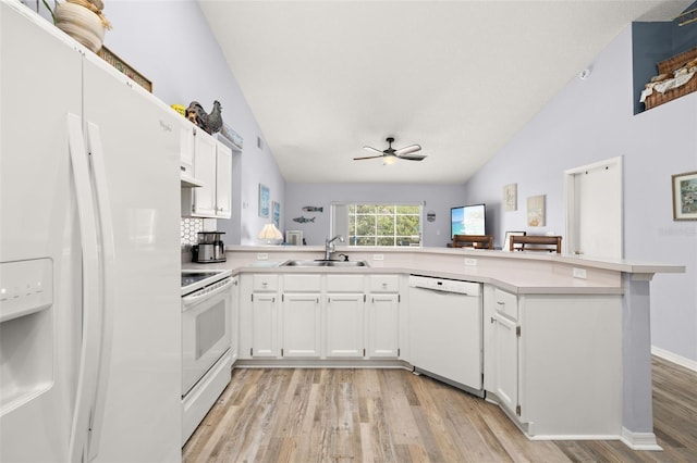 kitchen featuring white cabinetry, sink, white appliances, and kitchen peninsula