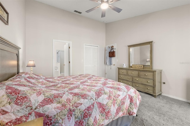 carpeted bedroom featuring ceiling fan and ensuite bath