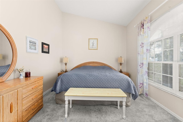 bedroom featuring lofted ceiling and light colored carpet