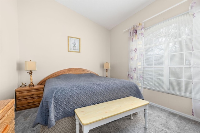 carpeted bedroom with vaulted ceiling