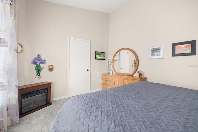 bedroom featuring carpet flooring and high vaulted ceiling