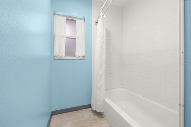 bathroom with shower / bath combo with shower curtain