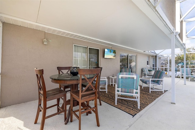 view of patio / terrace featuring a lanai