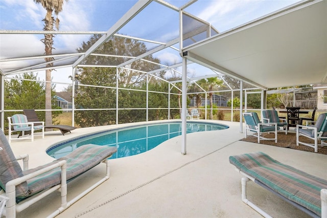 view of swimming pool with a patio area and glass enclosure