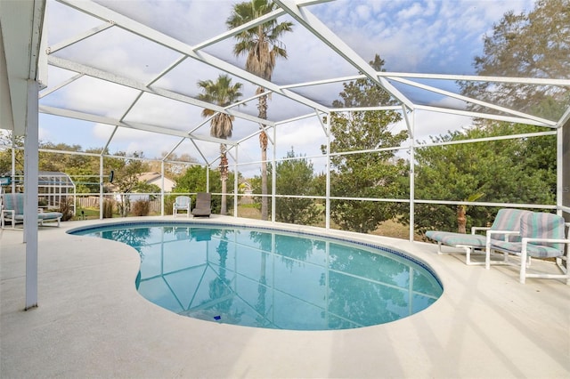 view of swimming pool featuring a lanai and a patio area