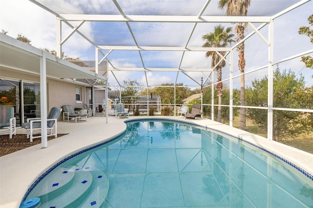 view of pool with a lanai and a patio