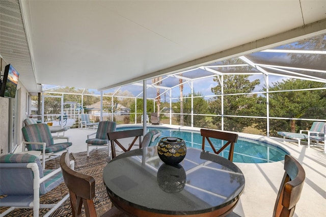 view of swimming pool featuring a patio and glass enclosure