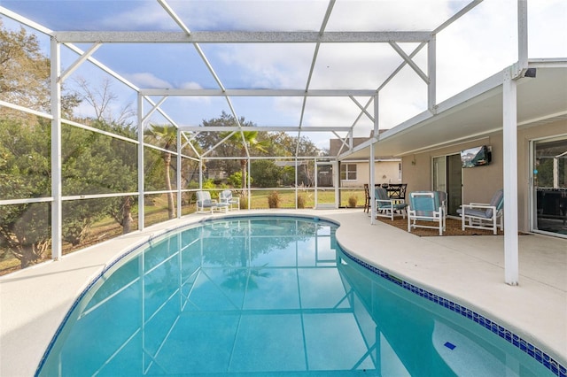 view of swimming pool with a patio and glass enclosure