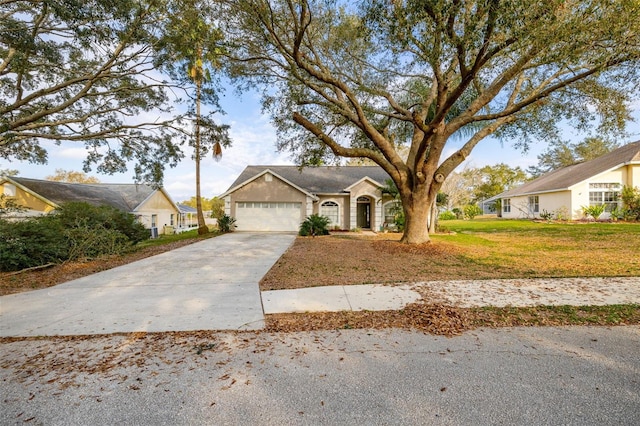 single story home with a garage and a front yard