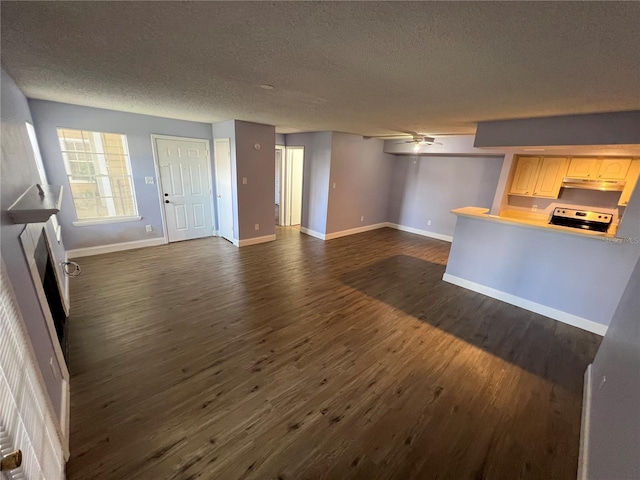 unfurnished living room with a textured ceiling, dark hardwood / wood-style floors, and ceiling fan