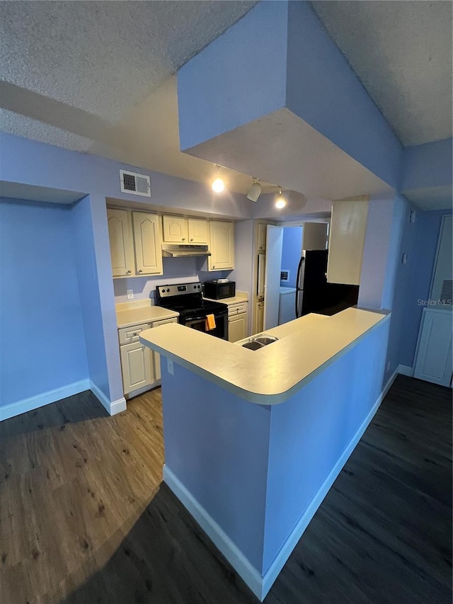 kitchen featuring hardwood / wood-style floors, refrigerator, stainless steel range with electric cooktop, kitchen peninsula, and a textured ceiling